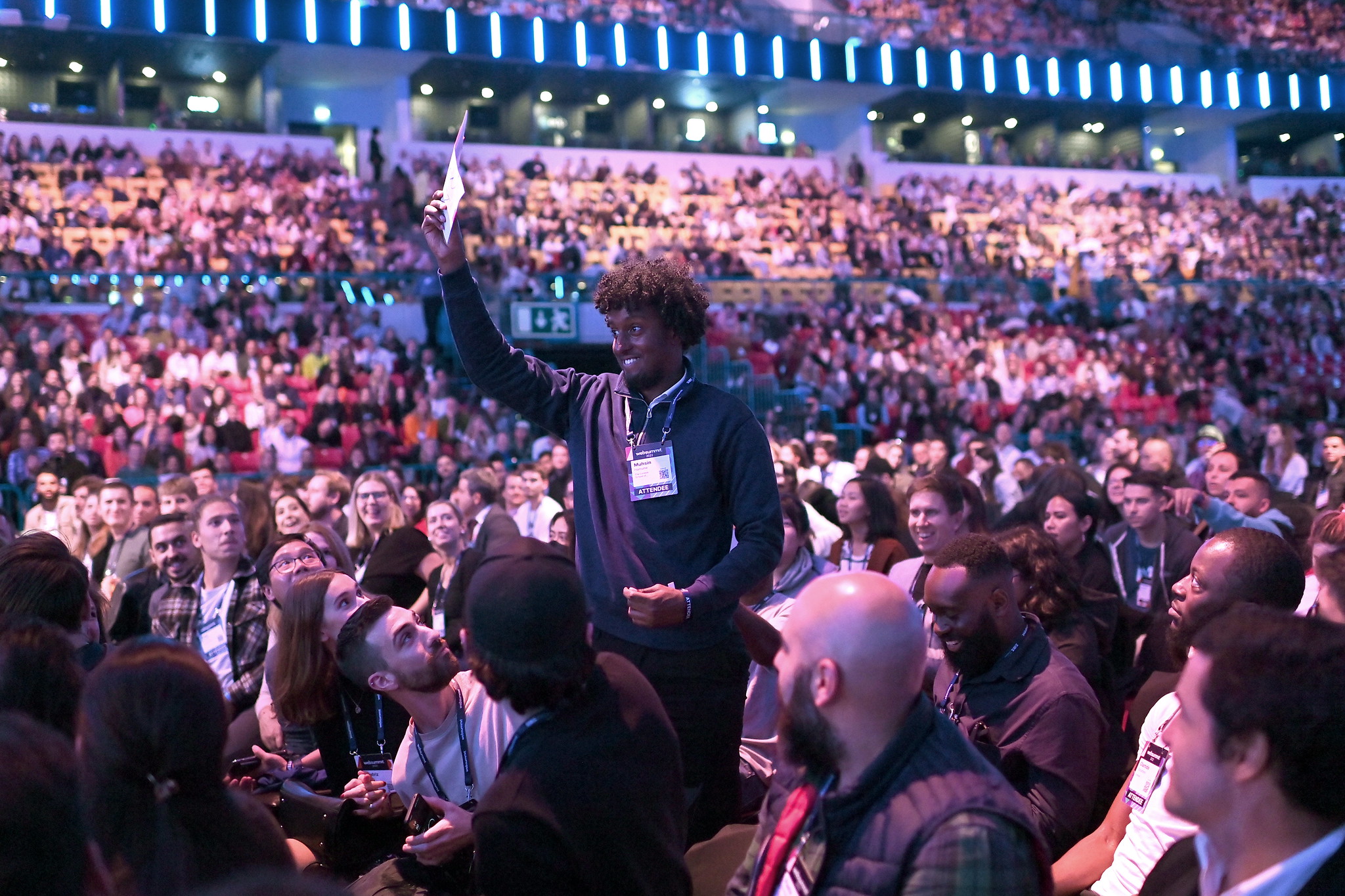 The Altice Arena in Lisbon is packed with people attending the Opening Night of Web Summit. In the centre of the picture is Golden Ticket winner Muhsin Hamume who is waving a ticket and smiling.