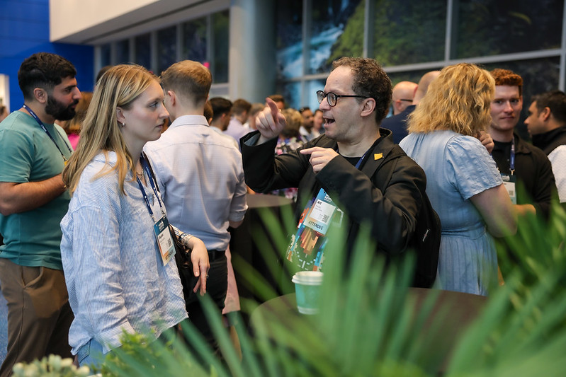 Attendees talk at a Calgary meetup during Web Summit Vancouver 2025