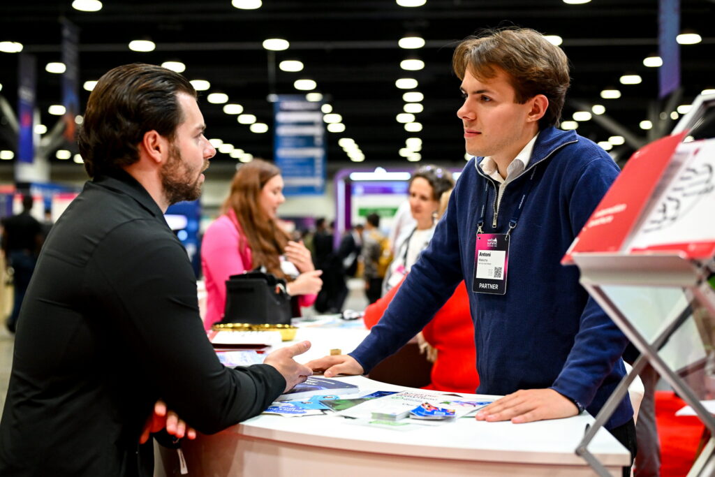 Two people talking at the City of Warsaw partner booth during day two of Web Summit Vancouver 2026